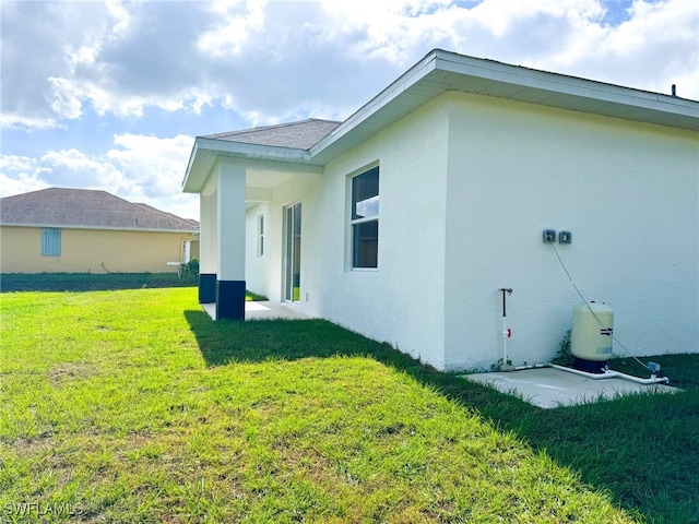 rear view of house featuring a lawn