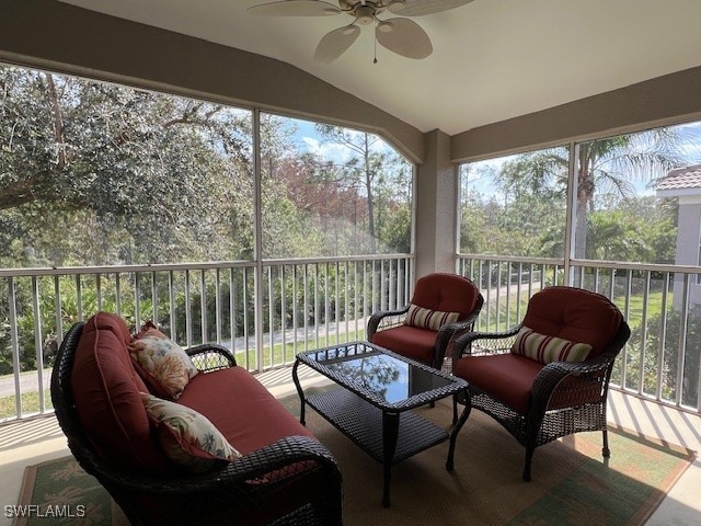 sunroom with plenty of natural light, ceiling fan, and lofted ceiling