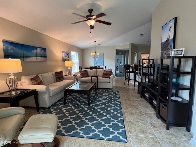 living room with tile patterned flooring, ceiling fan with notable chandelier, and vaulted ceiling