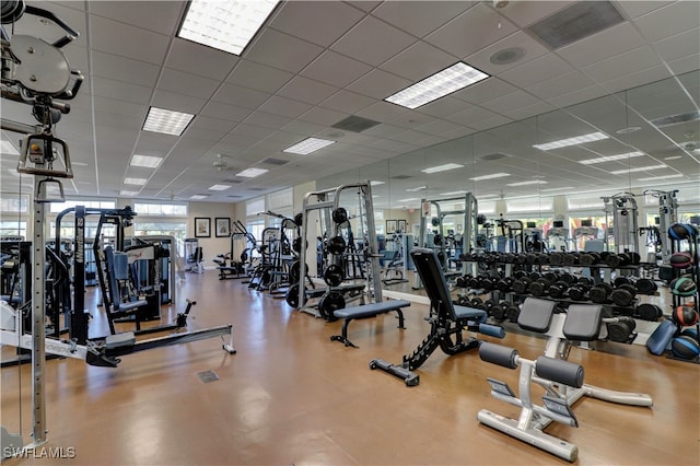 gym with a paneled ceiling