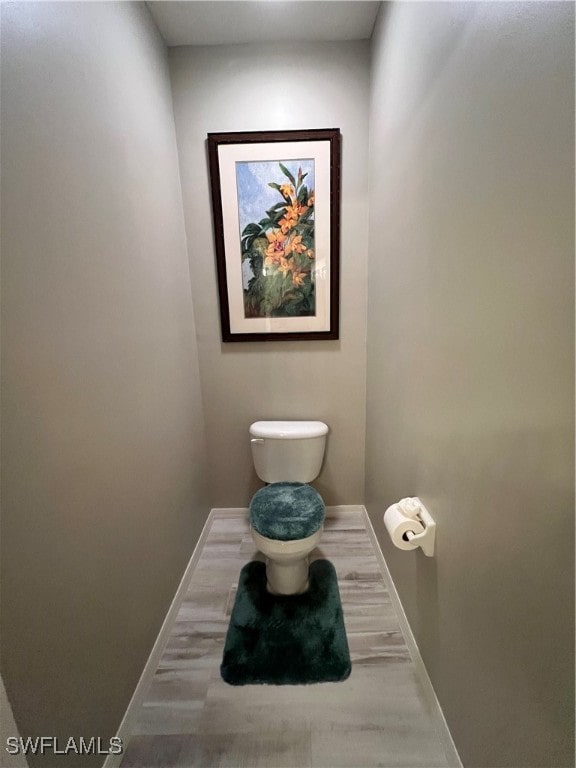 bathroom featuring hardwood / wood-style floors and toilet