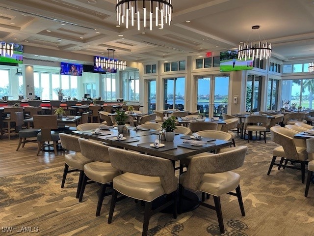 dining space featuring beam ceiling, wood-type flooring, and coffered ceiling