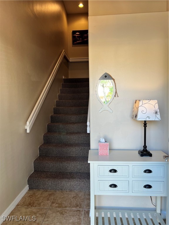 stairs with tile patterned floors