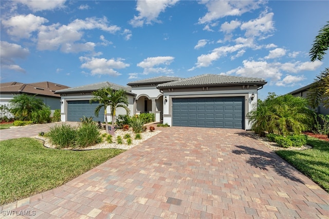 view of front of property with a front yard and a garage