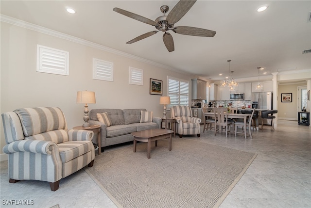 living room with crown molding and ceiling fan with notable chandelier