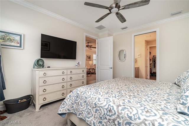 carpeted bedroom with crown molding, connected bathroom, and ceiling fan