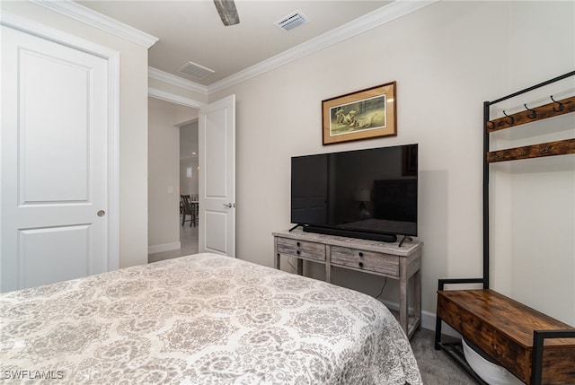 bedroom with ceiling fan, crown molding, and carpet floors