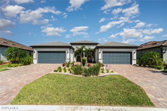 view of front of house featuring a front yard and a garage