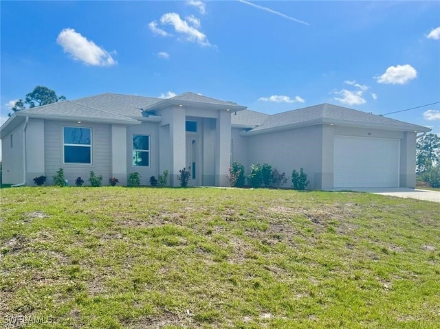 view of front facade featuring a front yard and a garage