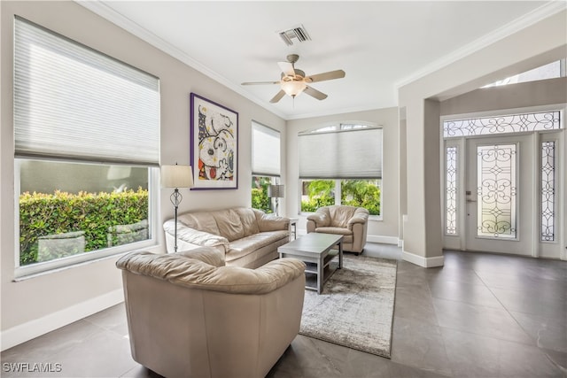 living room featuring crown molding, tile patterned flooring, and ceiling fan