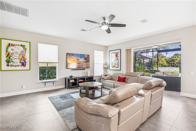 living room featuring light tile patterned floors, a wealth of natural light, and ceiling fan