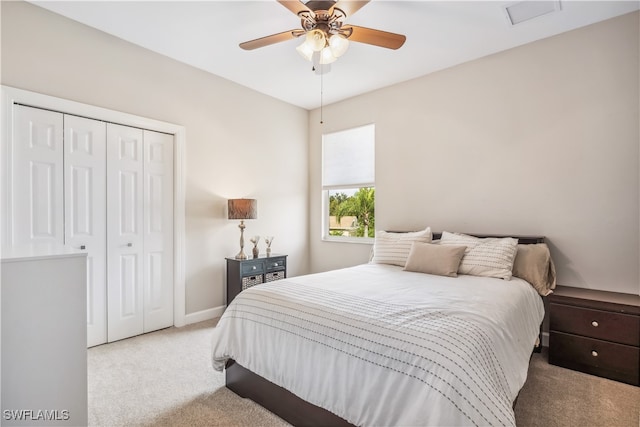 bedroom featuring light carpet, a closet, and ceiling fan