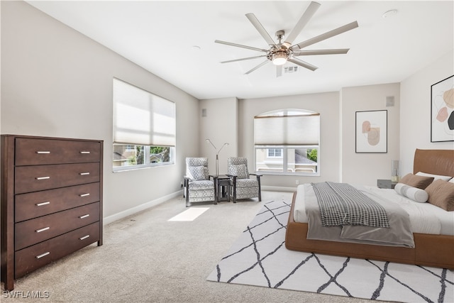 bedroom featuring light colored carpet and ceiling fan