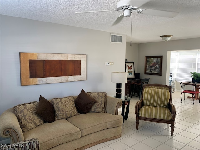 tiled living room featuring a textured ceiling and ceiling fan