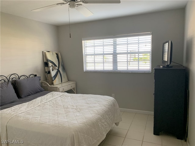 tiled bedroom with multiple windows and ceiling fan