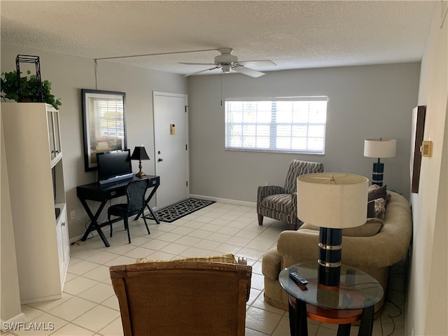 living room with ceiling fan, a textured ceiling, and light tile patterned floors