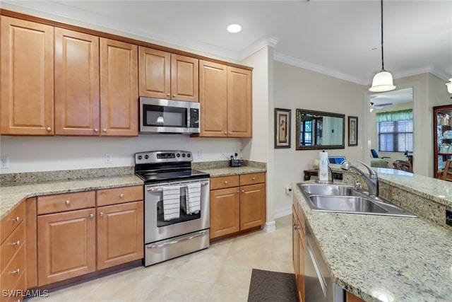 kitchen featuring light stone counters, appliances with stainless steel finishes, pendant lighting, crown molding, and sink