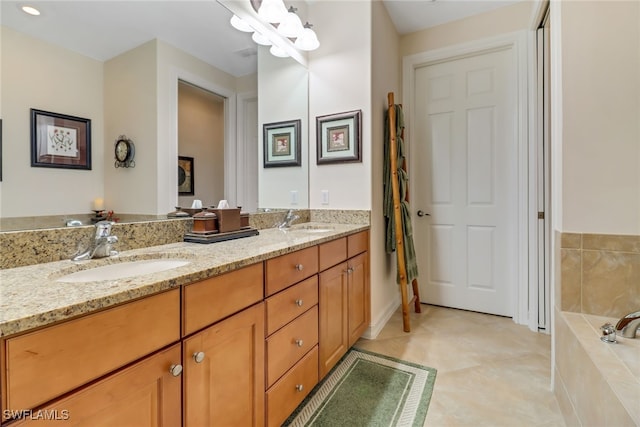 bathroom featuring vanity, tile patterned floors, and tiled tub