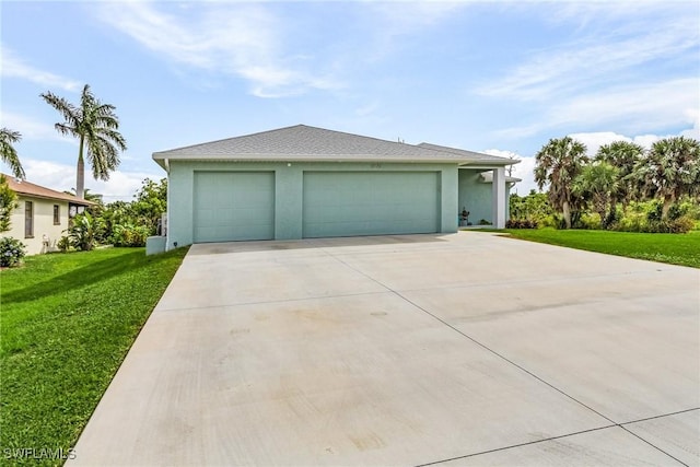 view of front facade with a garage and a front lawn