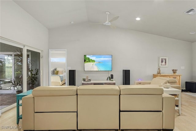 living room with light wood-type flooring, vaulted ceiling, and ceiling fan