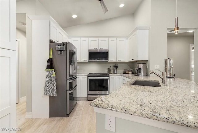 kitchen featuring light stone counters, sink, white cabinetry, and stainless steel appliances