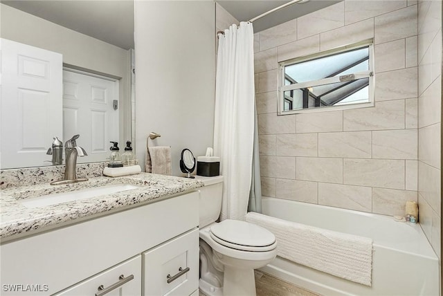 full bathroom with shower / bath combination with curtain, vanity, and toilet