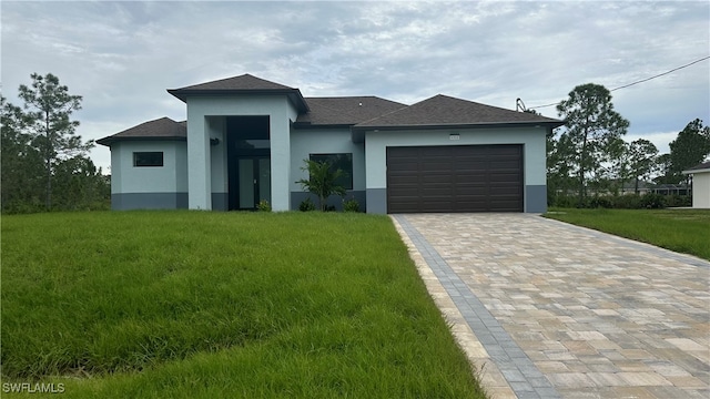 view of front of house featuring a garage and a front lawn