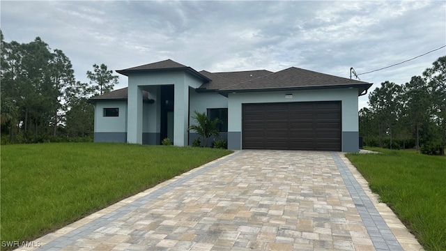 view of front facade with a front yard and a garage