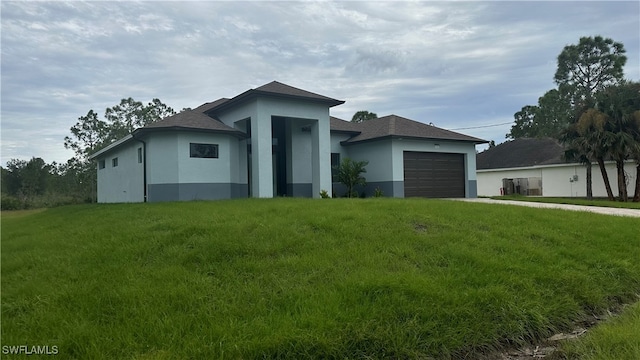 view of front of property with a garage and a front lawn