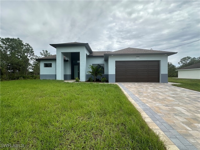 view of front facade with a front lawn and a garage