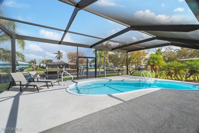 view of swimming pool with a patio and glass enclosure