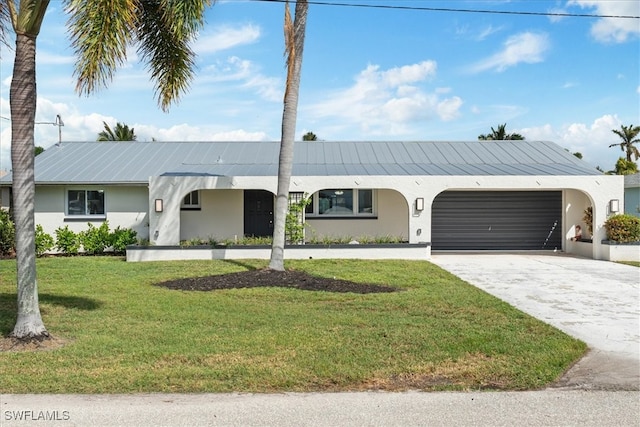 ranch-style home featuring a front yard and a garage