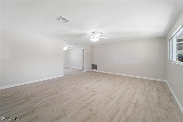 unfurnished room with ceiling fan and light wood-type flooring