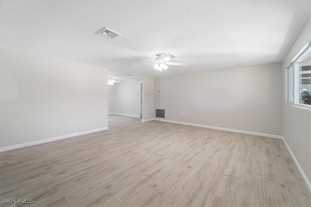 unfurnished room featuring a ceiling fan, light wood-type flooring, and visible vents