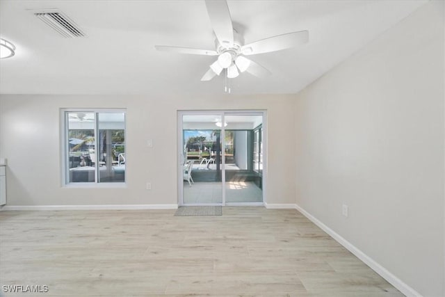 unfurnished room featuring a ceiling fan, baseboards, visible vents, and light wood finished floors