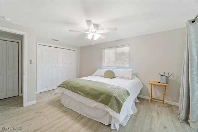 bedroom with ceiling fan, light wood-type flooring, and a closet