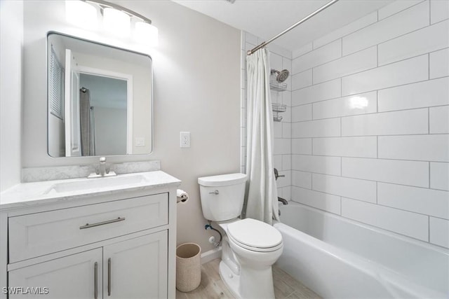 bathroom featuring vanity, wood finished floors, shower / bath combo with shower curtain, and toilet