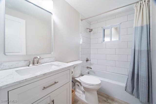 full bathroom with wood finished floors, shower / bath combo, vanity, and toilet