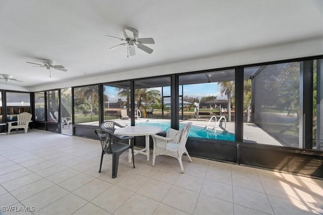 sunroom featuring plenty of natural light and a ceiling fan