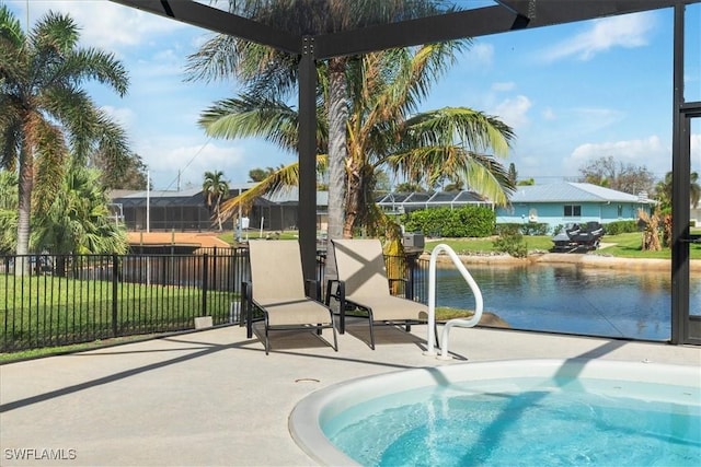 view of swimming pool with glass enclosure, a patio, and fence