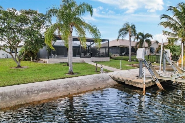 view of dock featuring glass enclosure, a lawn, and a water view