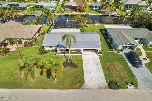 drone / aerial view with a water view and a residential view