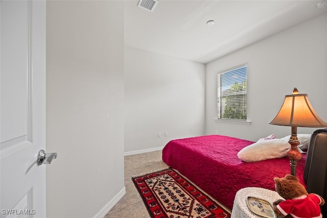 bedroom with light tile patterned floors