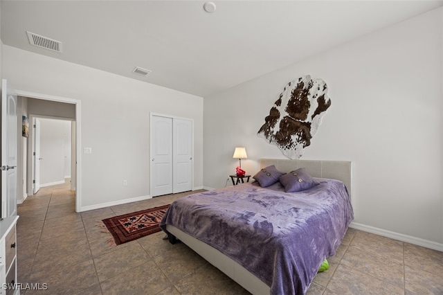 tiled bedroom with a closet