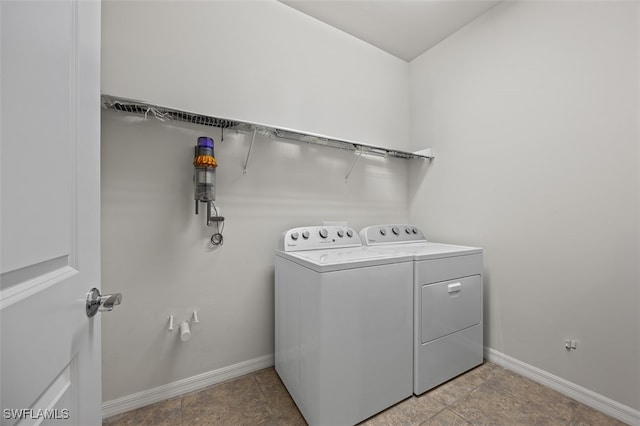 clothes washing area featuring washer and dryer