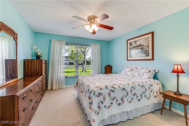 bedroom with light carpet, a textured ceiling, and ceiling fan