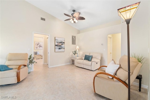 tiled living room with ceiling fan and high vaulted ceiling