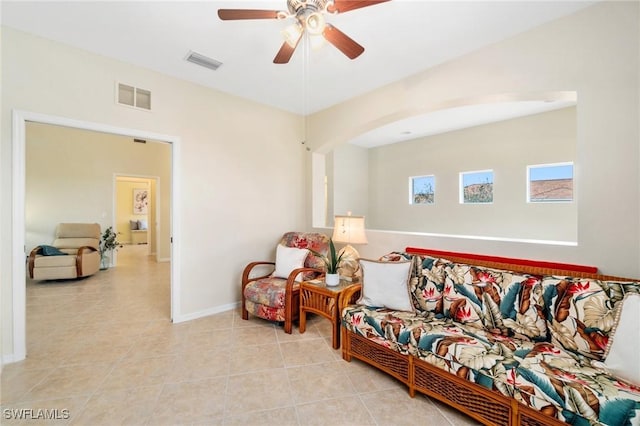 living room with ceiling fan and light tile patterned floors