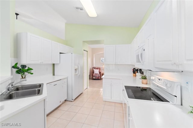 kitchen featuring light tile patterned floors, sink, white appliances, and white cabinets