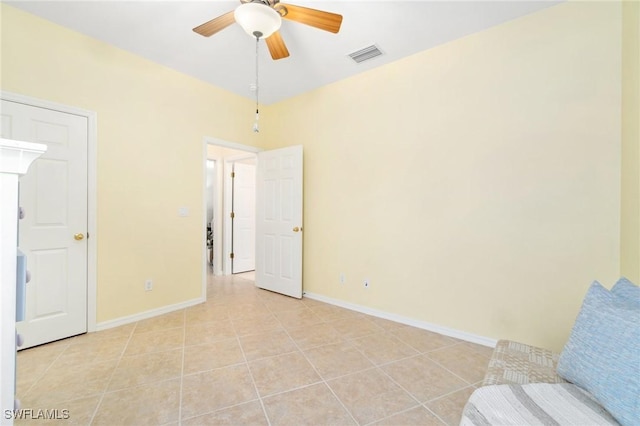 interior space with light tile patterned flooring and ceiling fan